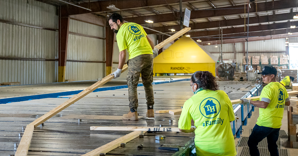 Truss Builders assembling roof truss at Crescent City True House facility